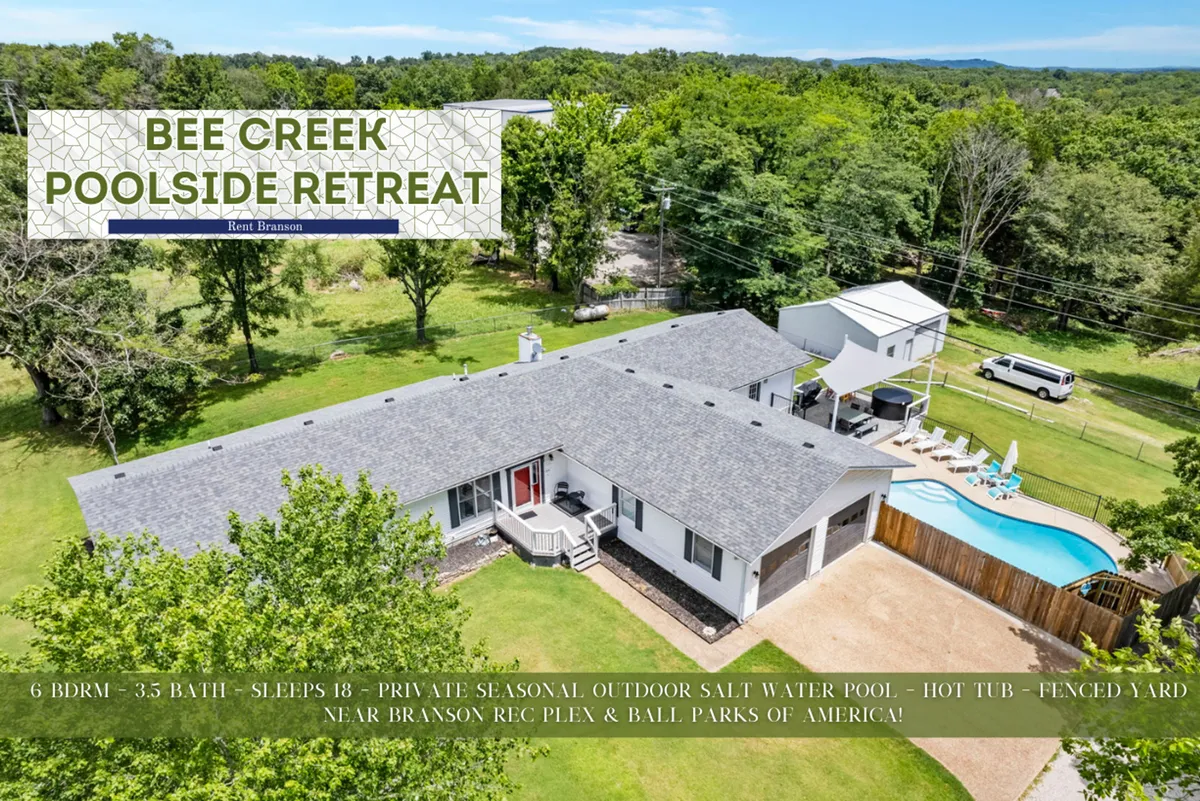 A cheerful exterior view showcasing the private outdoor pool, spacious fenced yard, hot tub, and the large house set up for gatherings. The space is designed for swimming, barbecuing, and relaxing with ample room for family activities.